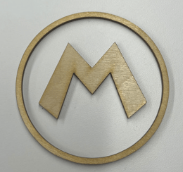 A thin wooden outline of a circle, with the classic Mario "m" cut-out placed in the center, placed on a white surface.